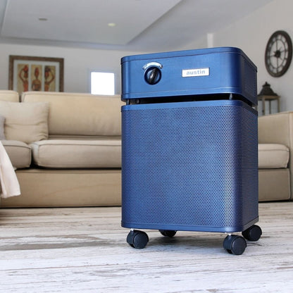 Austin Air HealthMate Plus Air Purifier, Midnight Blue, in a living room