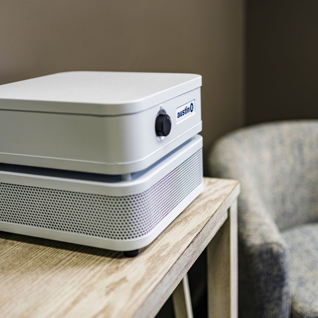 Austin Air it Personal air purifier, on a side table